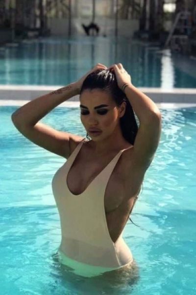 Cece is wearing a light colour swim suit 