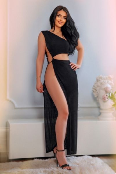 Babe has on a very long black dress and strappy high heels in this picture 